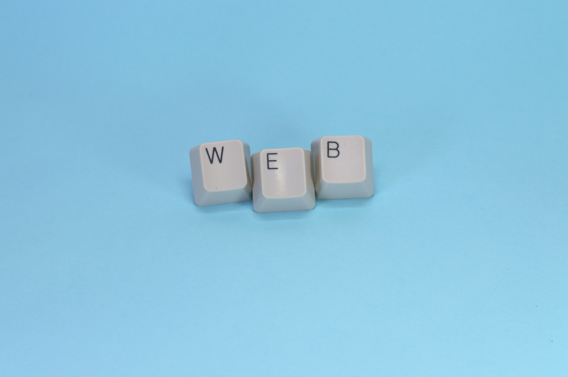 Keyboard keys spell out the word "web."